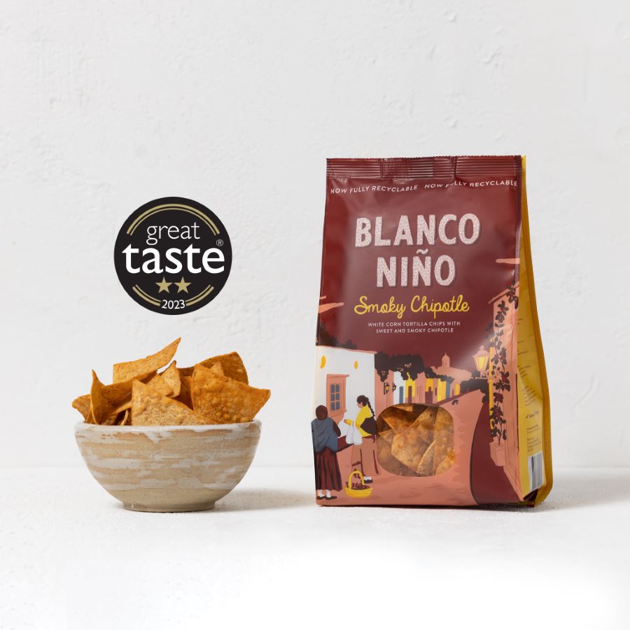 Bag of Blanco Niño tortilla chips with a bowl of chips on a white background