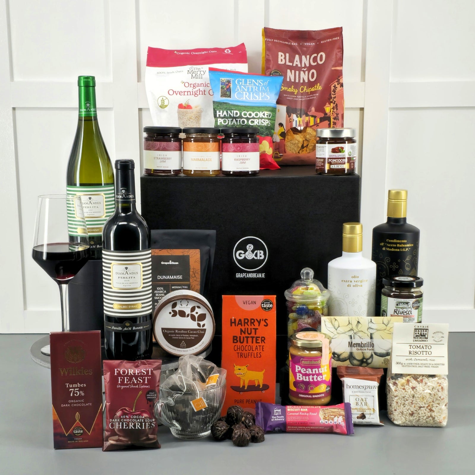 Deluxe vegan hamper with red and white wine, chocolate, coffee, tea, olive oil, balsalmic, quince paste, risotto, jams, oats, crisps, peanut butter, jellies.