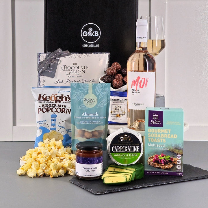 Gluten free hamper including popcorn, chocolate, cheese, chutney and rose wine in a black gift box