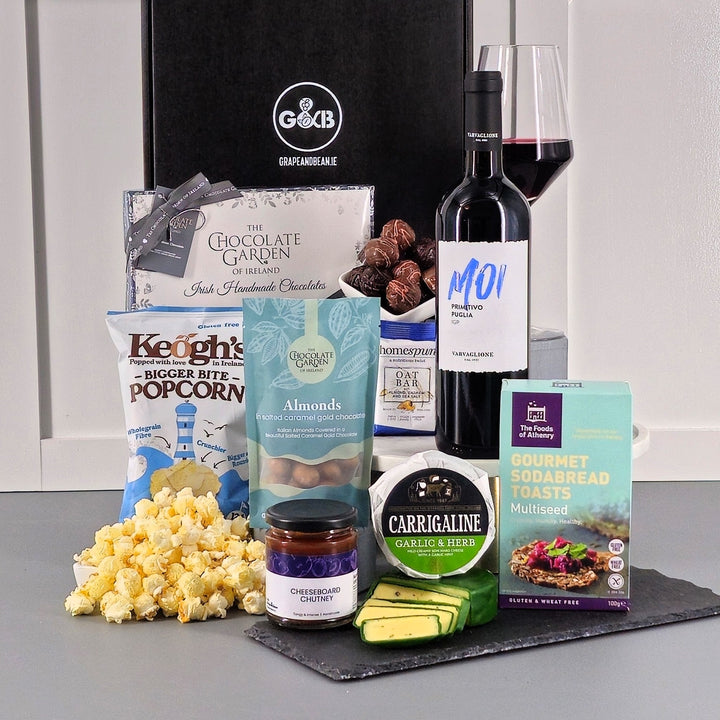 Gourmet gift  box with chocolate, cheese, chutney, poporn, sodabread  toasts and red wine