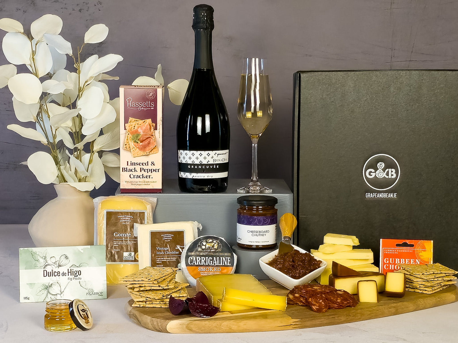 Gourmet food hamperwith cheeses, crackers, chutney, fig paste, chorizo and prosecco in a black gift box