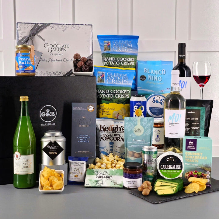 Deluxe hamper – gluten-free treats with red wine and white wine, crisps, chocolate, cheese, chutney, apple juice, t4ea, coffee, popcorn, fig paste, peanut butter and sodabread toasts.