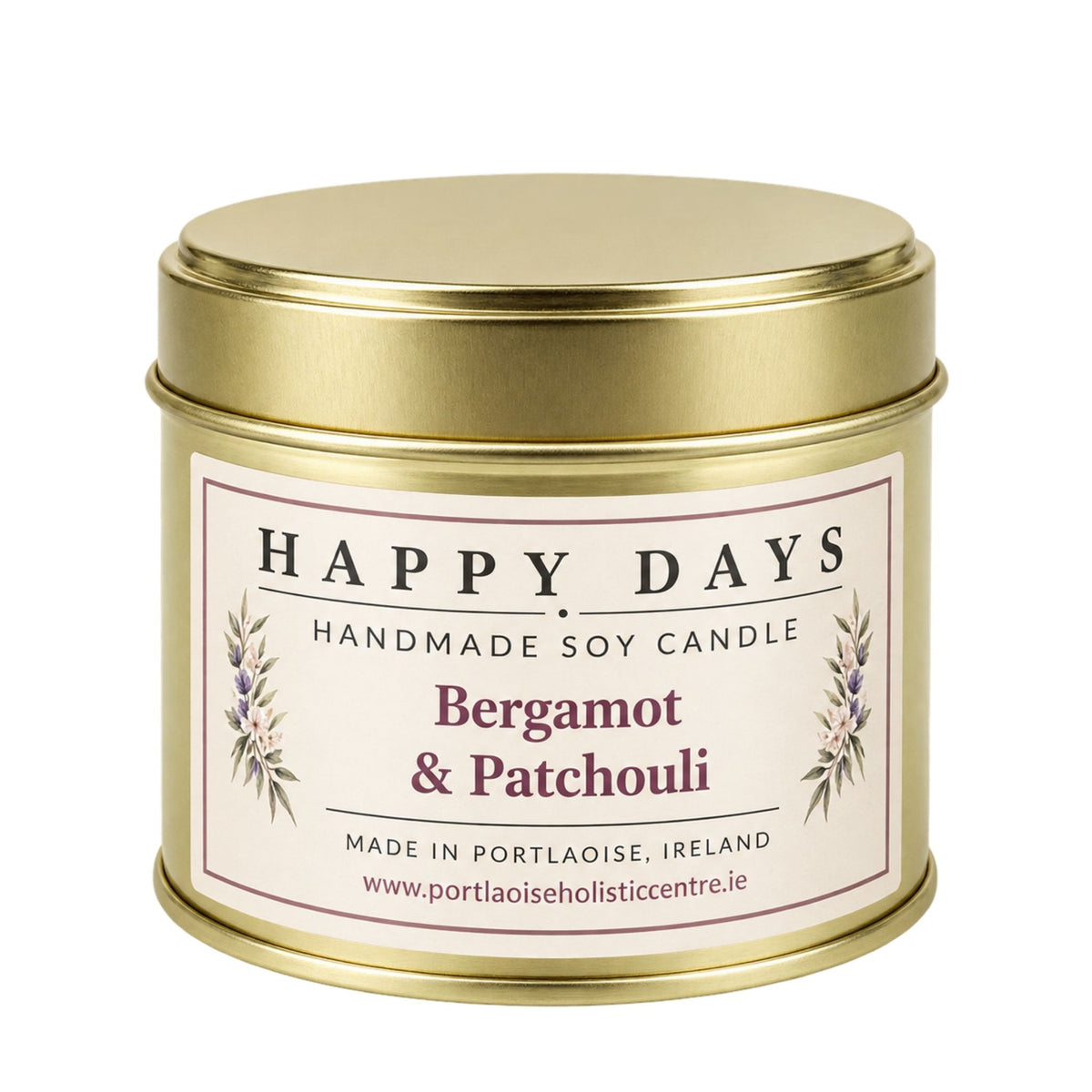 A gold metal tin candle with a cream-colored label reading 'HAPPY DAYS HANDMADE SOY CANDLE Bergamot & Patchouli' on a plain white background.