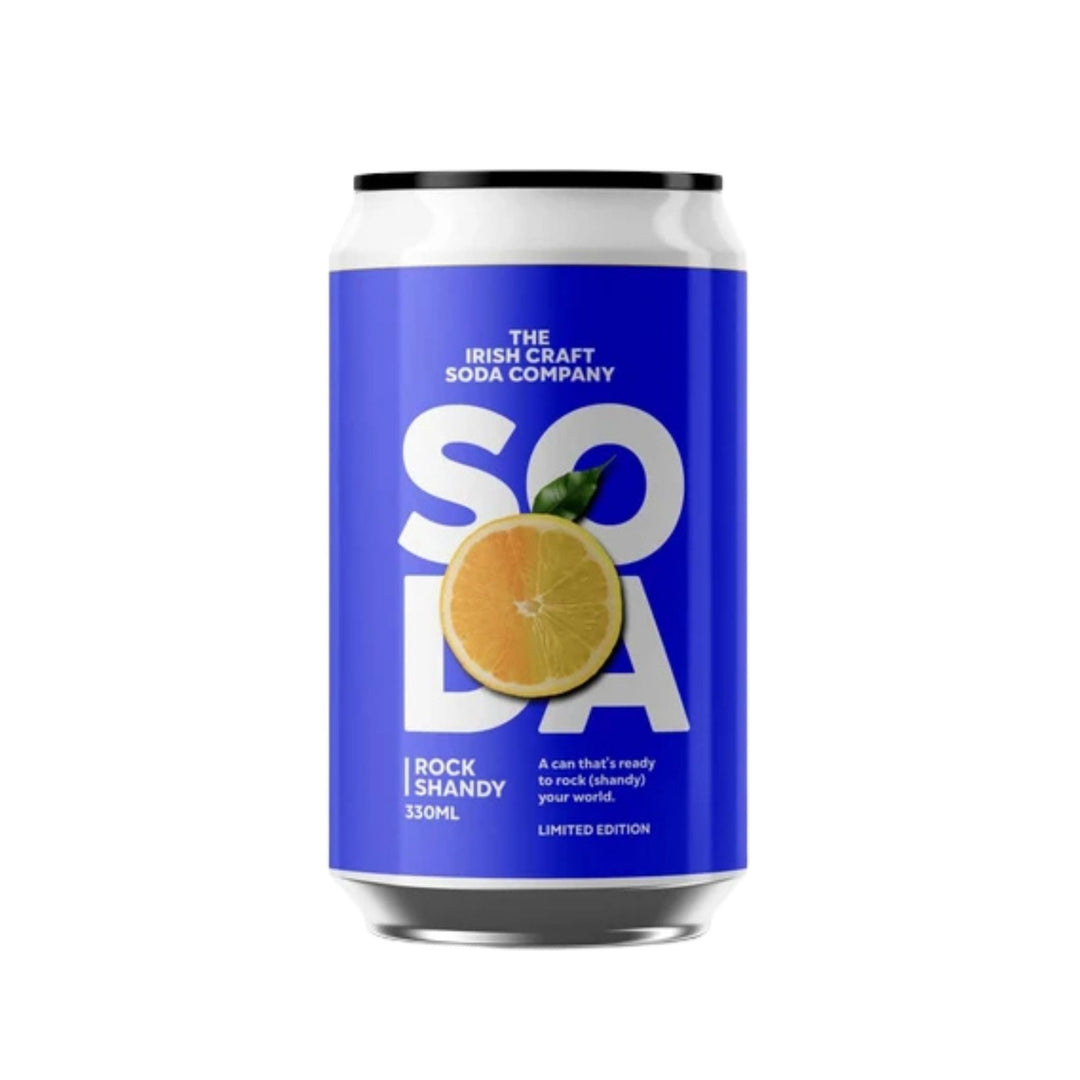 A 330mL aluminum can of The Irish Craft Soda Company Rock Shandy, featuring a vibrant blue label with a large white &