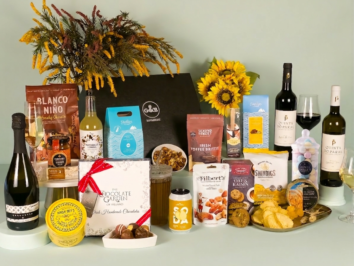 Assorted gourmet food and wine products on a table with decorative elements.