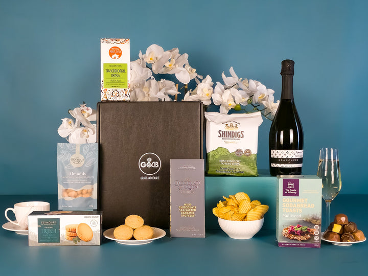 Artisan hamper with chocolate, sodabread toasts, crisps, tea, shortbread and Prosecco