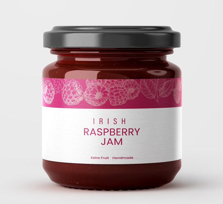 Jar of Irish Raspberry Jam with a pink label on a white background