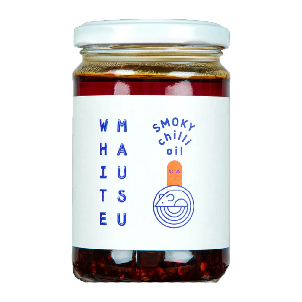 A glass jar of Whaiuteu Smoky Chilli Oil with a white label and white lid, set against a plain white background.